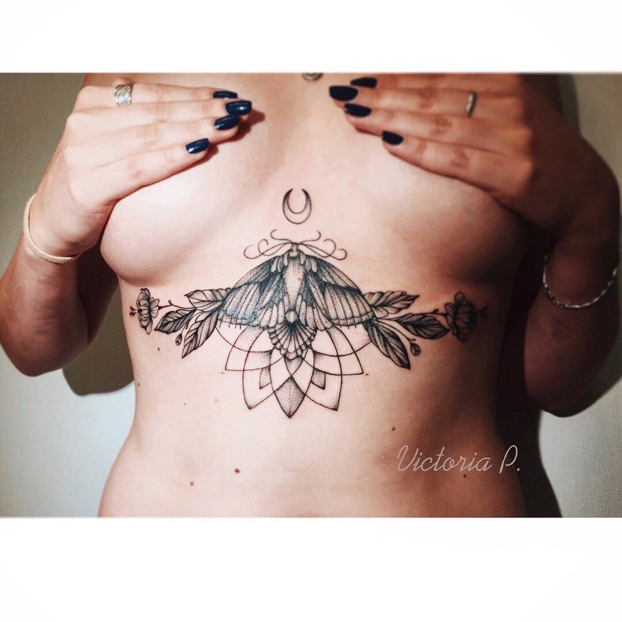 Bird under breast tattoo